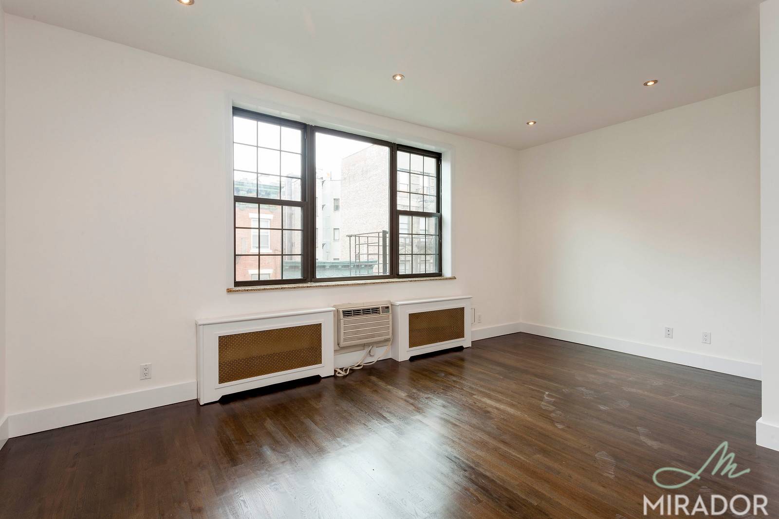 A massive private roof deck sits atop this airy alcove studio in a prime SoHo location.