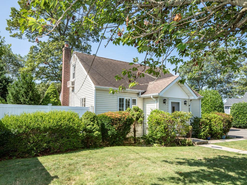 View of front of property featuring roof with shingles and a chimney