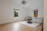 Living room featuring lofted ceiling, plenty of natural light, and light wood-style flooring