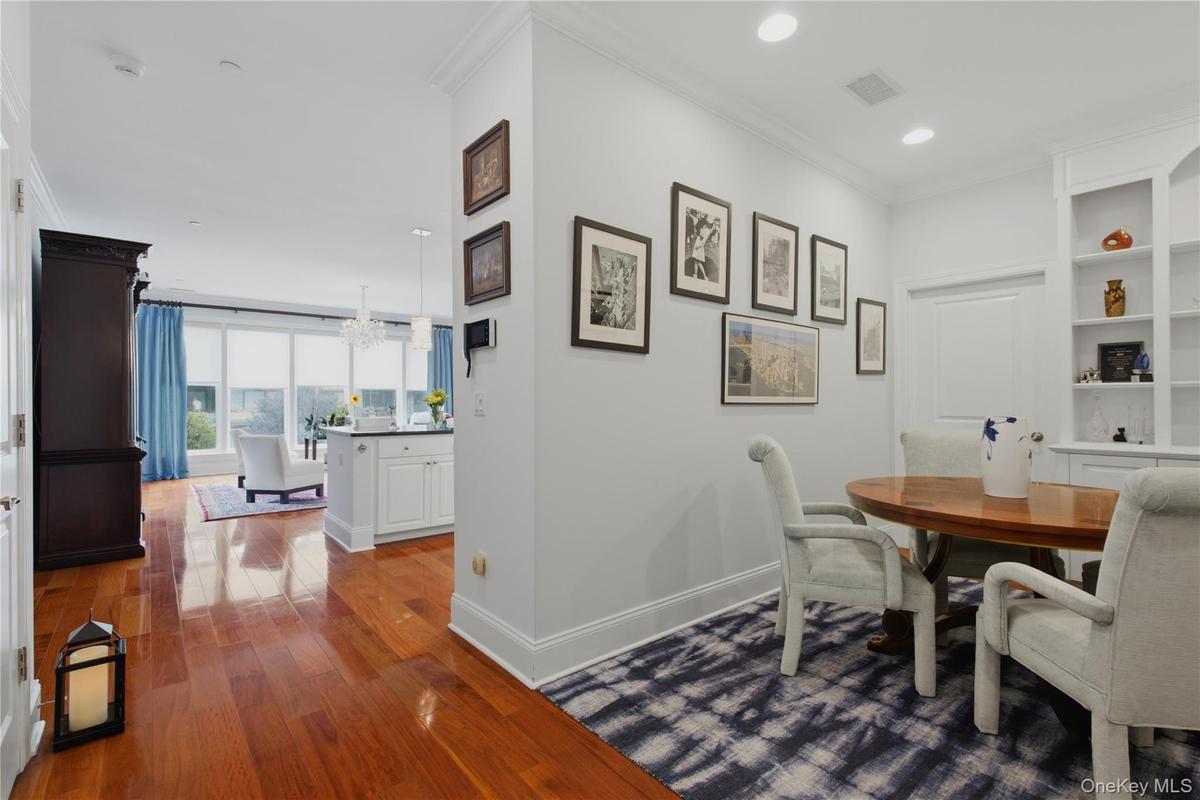 View from the den/office showcasing the homes open-concept layout and seamless flow to the kitchen and living room