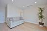 Living area with light wood-type flooring and recessed lighting