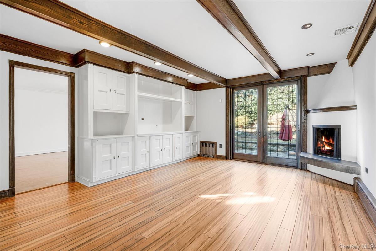 Family room with fireplace. French doors to large patio and backyard.