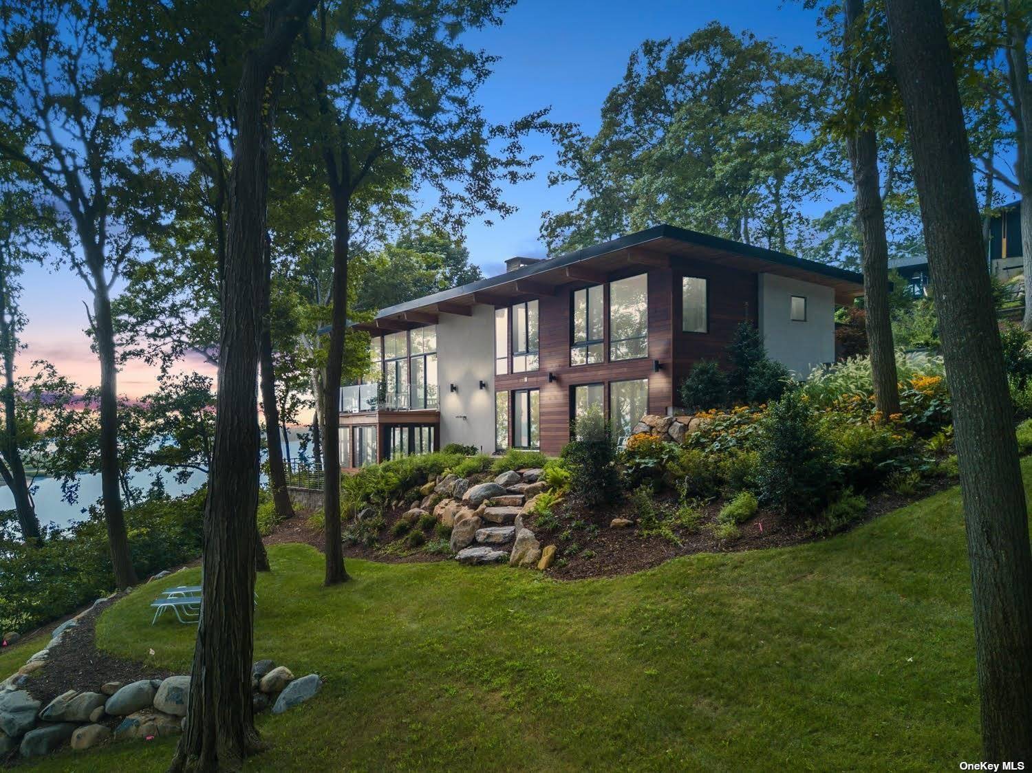 This irreplaceable waterfront home is perched on a gentle bluff with sweeping vistas.
