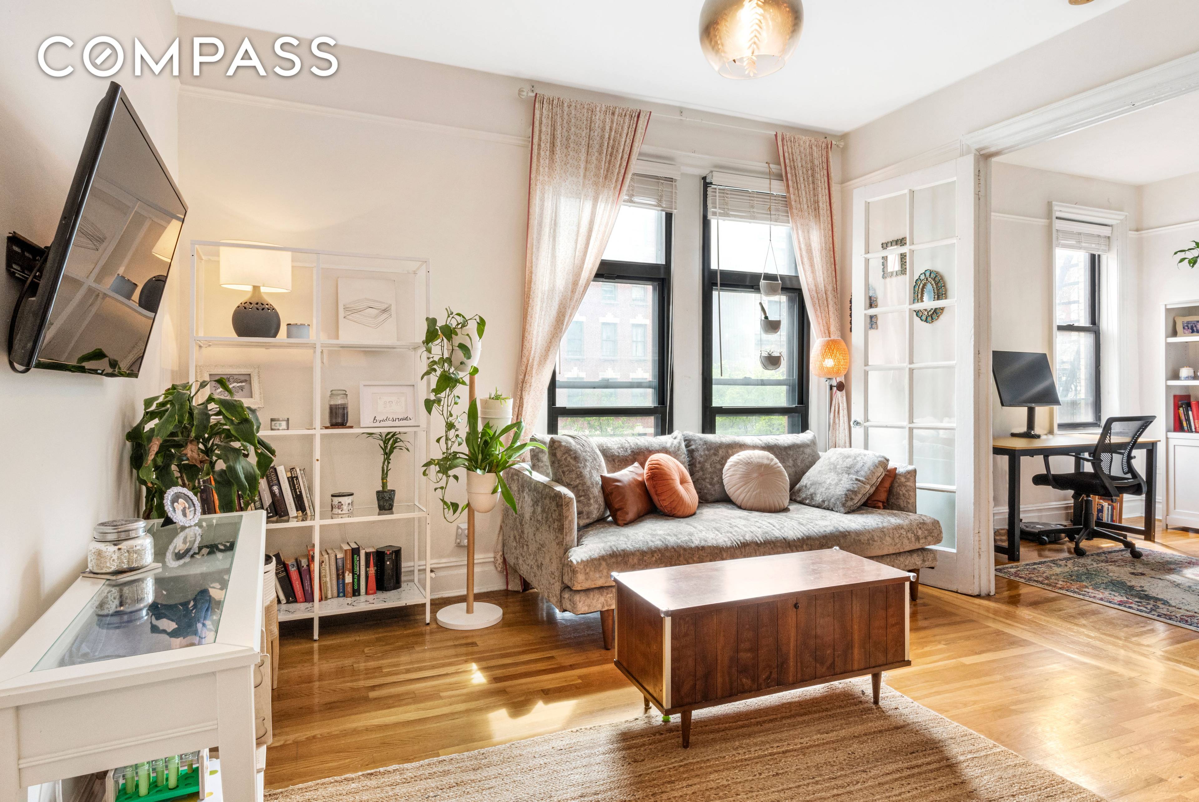 This charming prewar three bedroom or two bedroom home office apartment features oversized windows in the main living spaces and a newly renovated kitchen and bathroom.