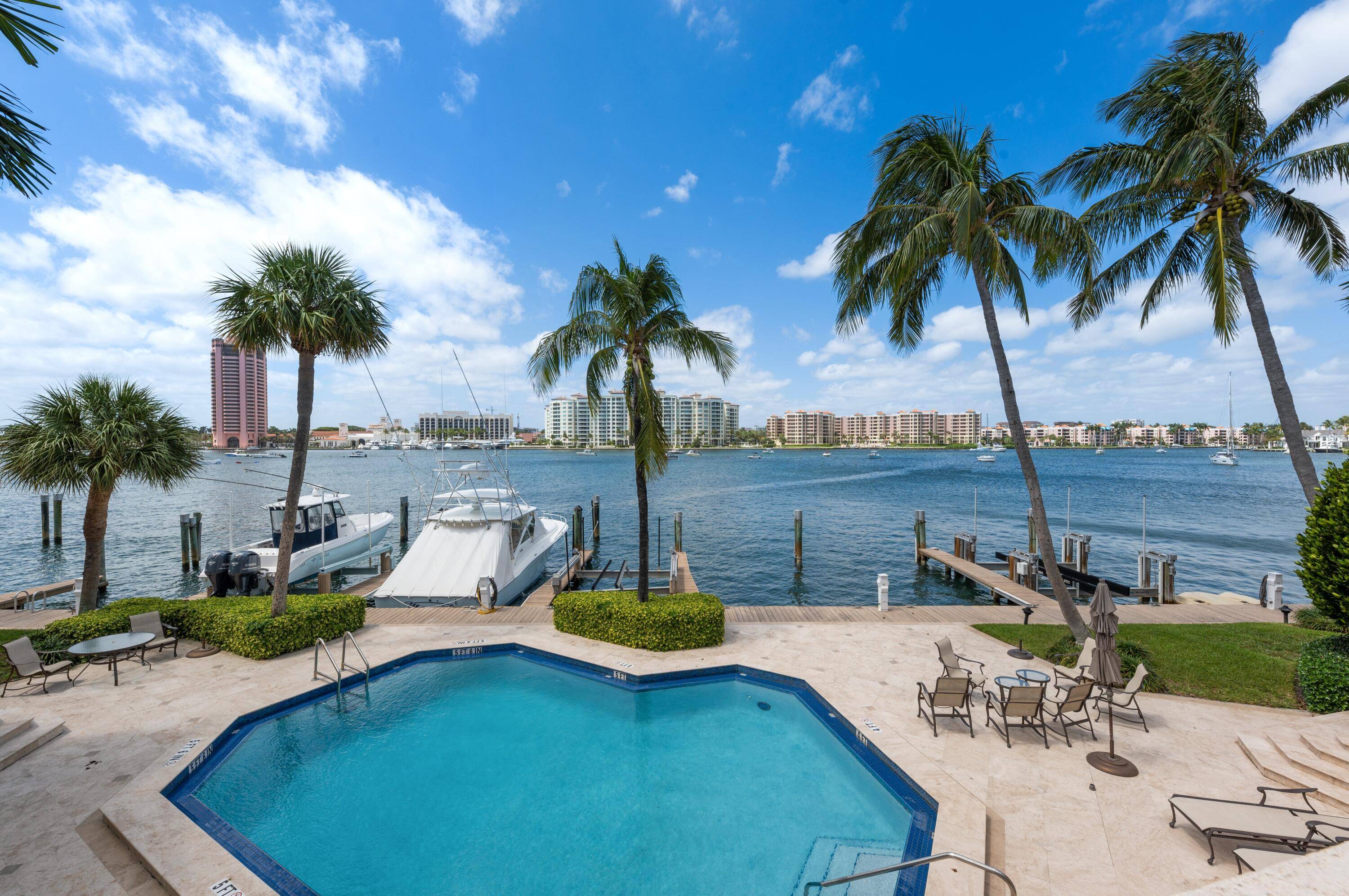 ABSOLUTELY STUNNING TOWNHOME ON LAKE BOCA WITH PRIVATE 50FT BOAT DOCK !
