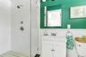 Bathroom with vanity, toilet, and tiled shower