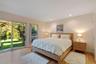 Bedroom with access to exterior, light wood-style flooring, and recessed lighting
