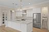 Gourmet kitchen is a chefs dream, centered around large island with sink and elegant pendant lighting. Stainless steel appliance, extensive cabinety