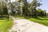 Additional entrance with brand-new limestone driveway leads through the property, offering easy access to the home and barns.