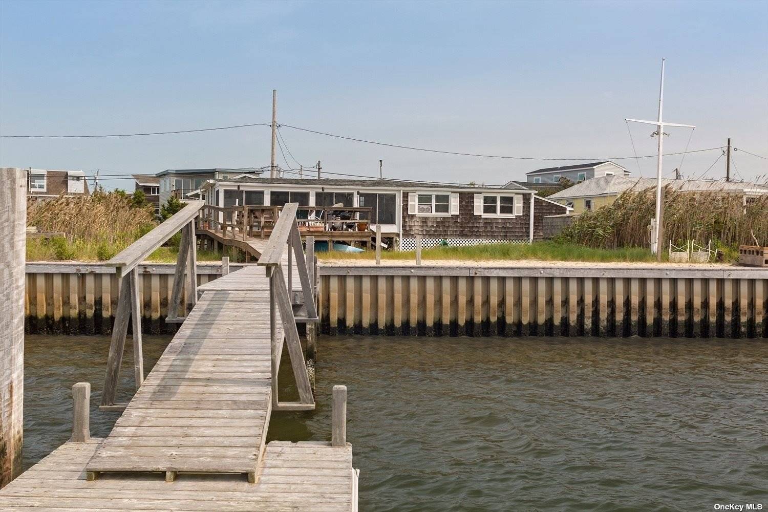 Nestled just off Dune Road on Pond Point, this delightful beach retreat features three to four bedrooms and two bathrooms, accommodating up to eight guests.