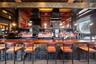 Community bar area with a towering ceiling and wood counters