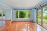 Empty room featuring wood-type flooring, a baseboard radiator, and recessed lighting