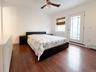 Bedroom with access to outside, dark wood finished floors, and a ceiling fan