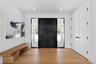 Foyer with light wood finished floors and recessed lighting