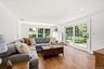 Sliding Doors open to a blue stone patio overlooking the yard.