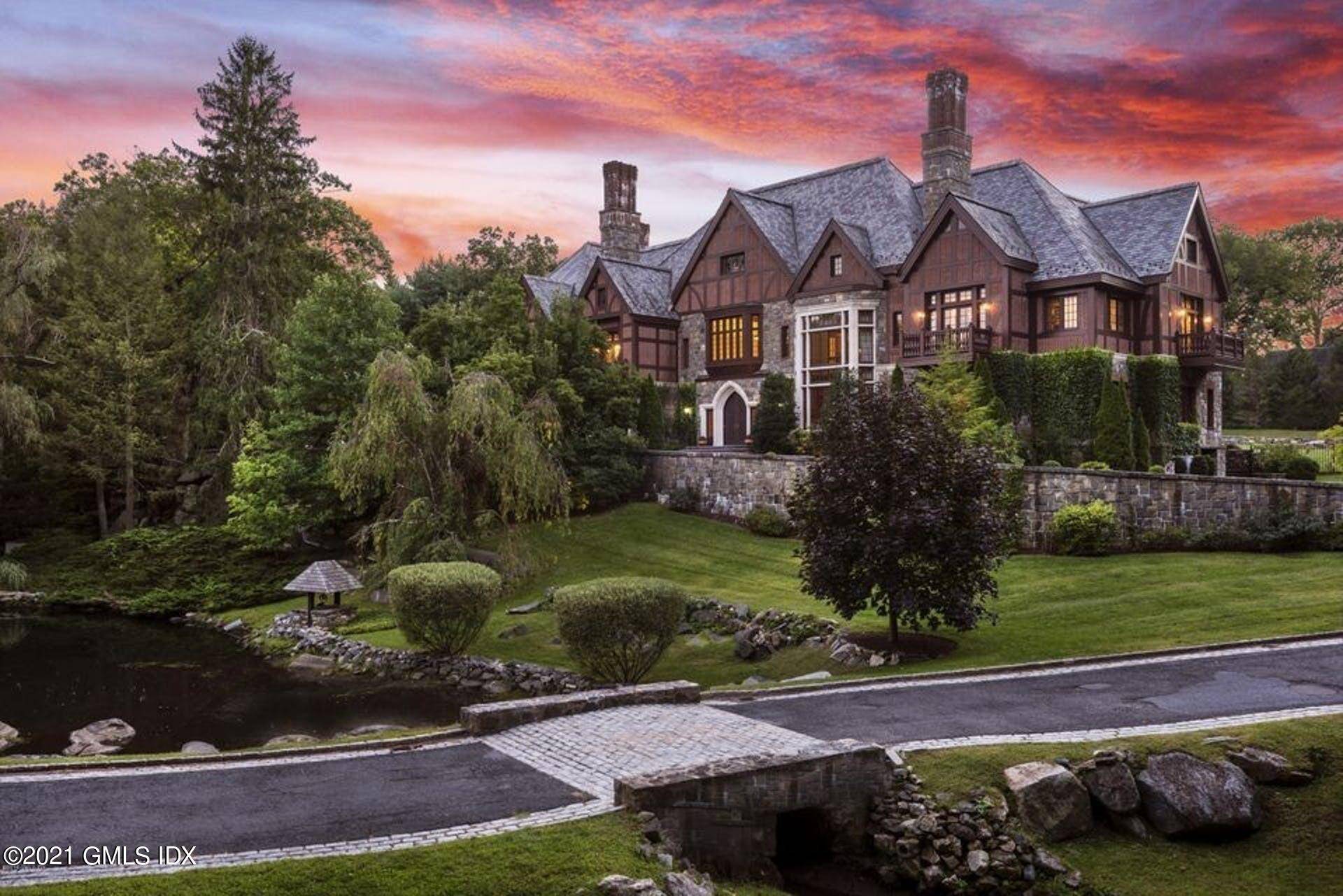 This extraordinary stone, brick and slate European manor style residence is prominently sited above a lovely free flowing pond on 4 acres in a prime mid country location.