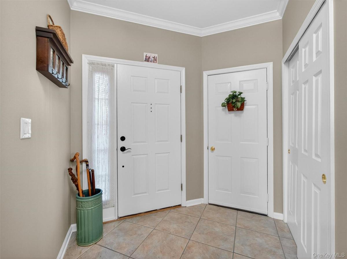 Doors leading to the entry pathway, the garage, and a closet.