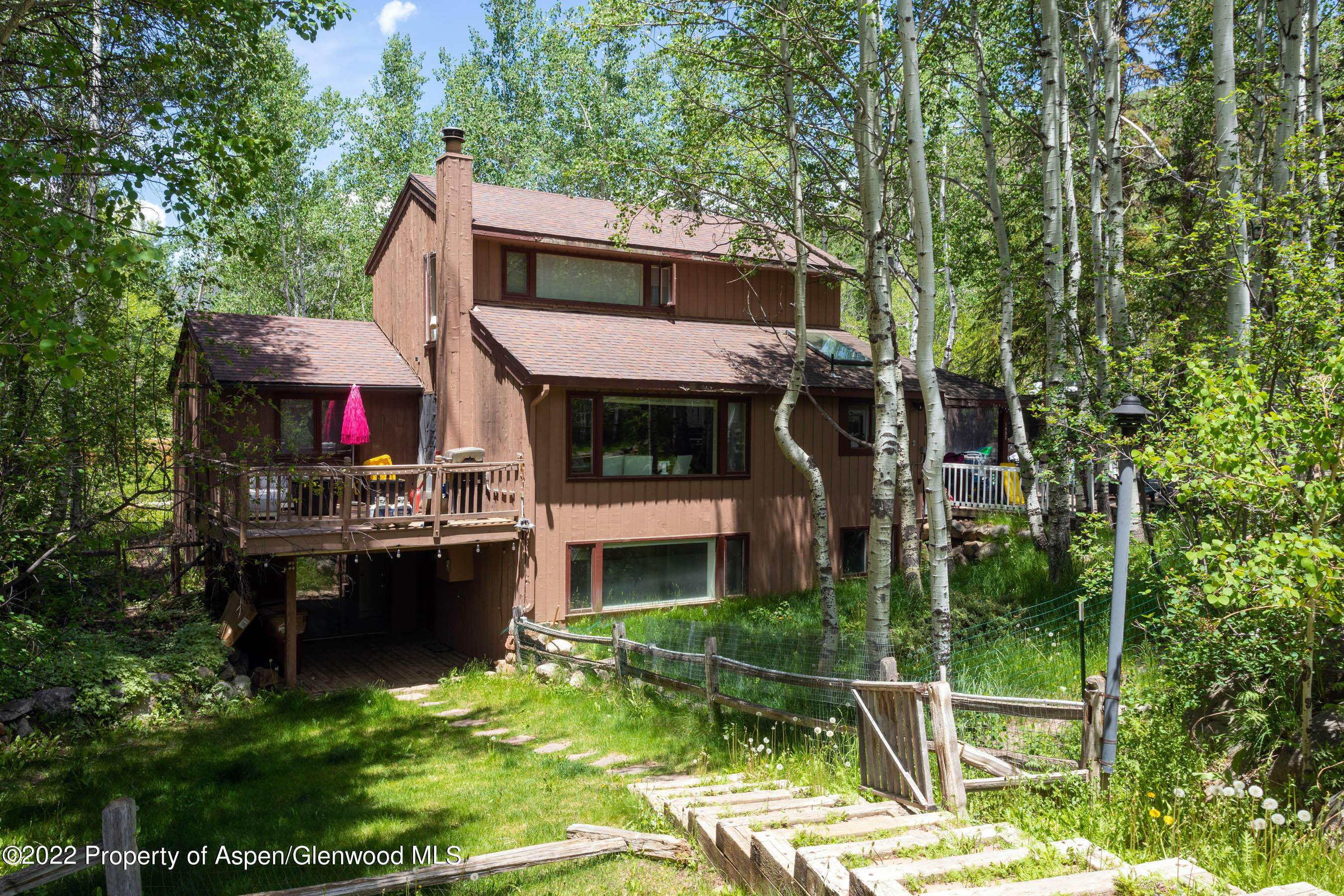 This five bedroom, five full bathroom home is tucked in with mature Aspen trees as if it were always meant to be there.