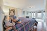 Bedroom featuring connected bathroom, french doors, hardwood / wood-style floors, and ornamental molding