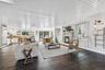 Living room with a glass covered fireplace and wood finished floors