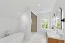 Bathroom featuring a freestanding bath, a shower stall, double vanity, recessed lighting, and vaulted ceiling
