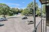 View of asphalt street with view of wooded area