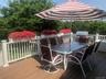 Wooden terrace with area for grilling and outdoor dining space
