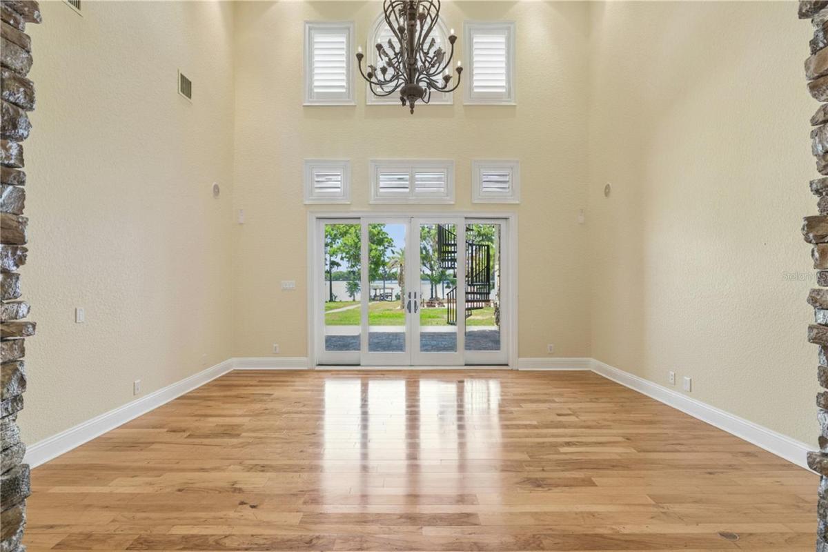 Living Room: Coffered Tray Ceilings with Crown Molding & Accent under mounted lighting Soaring 24’ Ceiling