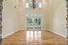 Living Room: Coffered Tray Ceilings with Crown Molding & Accent under mounted lighting Soaring 24’ Ceiling