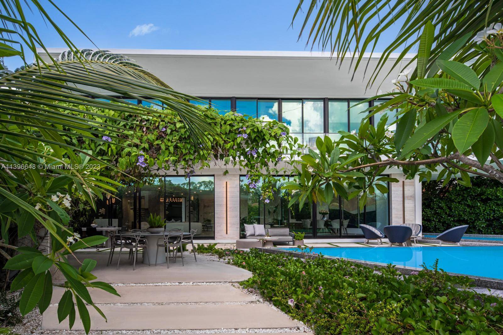 Step Inside With Me ! Draped in bougainvillea, this modern waterfront on coveted lower North Bay Road is open to SELLER FINANCING.