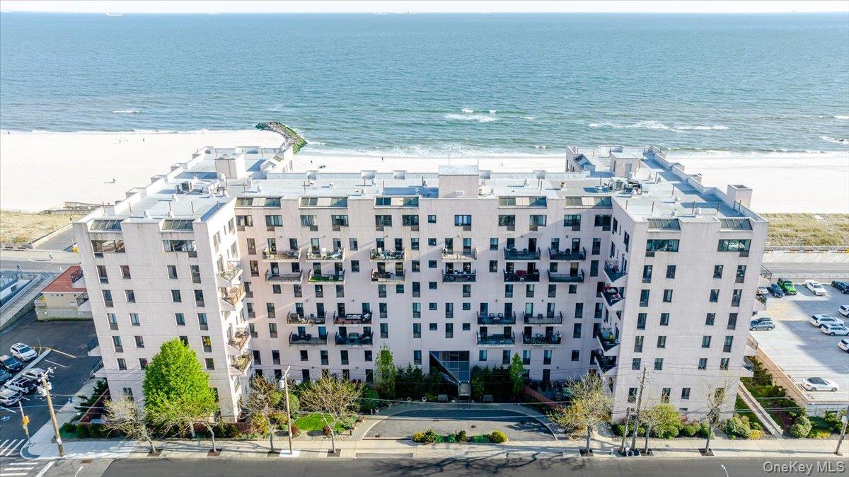 Drone / aerial view of apartment complex / building and unending shoreline