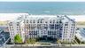 Drone / aerial view of apartment complex / building and unending shoreline