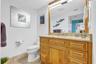 Oakwood primary bathroom With polished granite surfaces. Stainless steel steel turned handles And mirror
