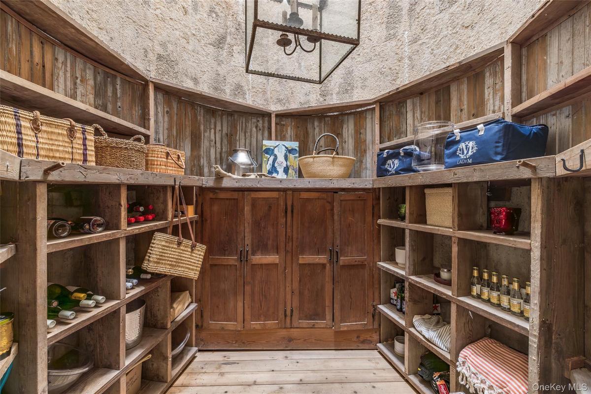 Wine area with wooden walls and light wood-style floors