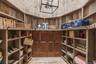 Wine area with wooden walls and light wood-style floors