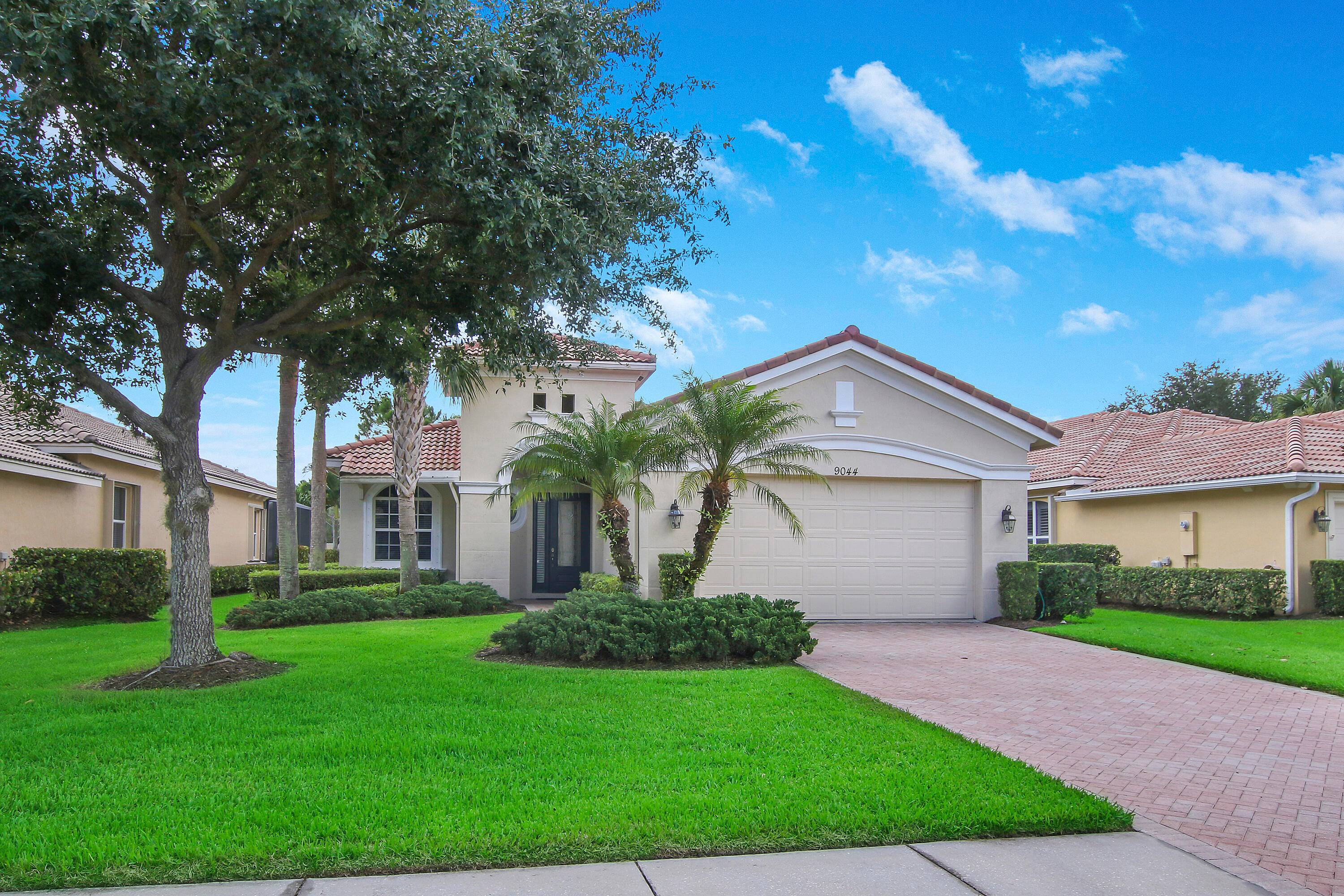 Meticulous 3BR 2BA 2CG 'Fairview' plan in the 24 hour guard gated community of PGA Village with LAKE VIEWS and just steps to the community clubhouse !