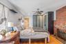 Bedroom featuring a brick fireplace, light wood-type flooring, ceiling fan, a closet, and recessed lighting
