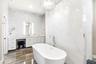 Marble Walls and Ceiling to Counter glass tiled backspace, backglowing mirrors and attached hanging magnifying mirror.
