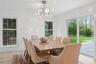 Dining space with an inviting chandelier, a healthy amount of sunlight, light wood-style floors, and visible vents