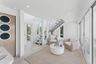 Sitting room featuring baseboards, recessed lighting, stairway, and a healthy amount of sunlight