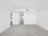 Primary bedroom looking to hall to private bath