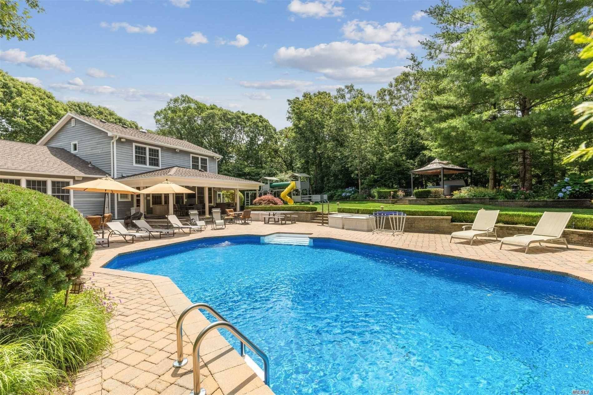 A true Hampton's Retreat your own private oasis complete with heated pool, hot tub, covered porches and pavilion surrounded by an estate like setting will take your breath away.