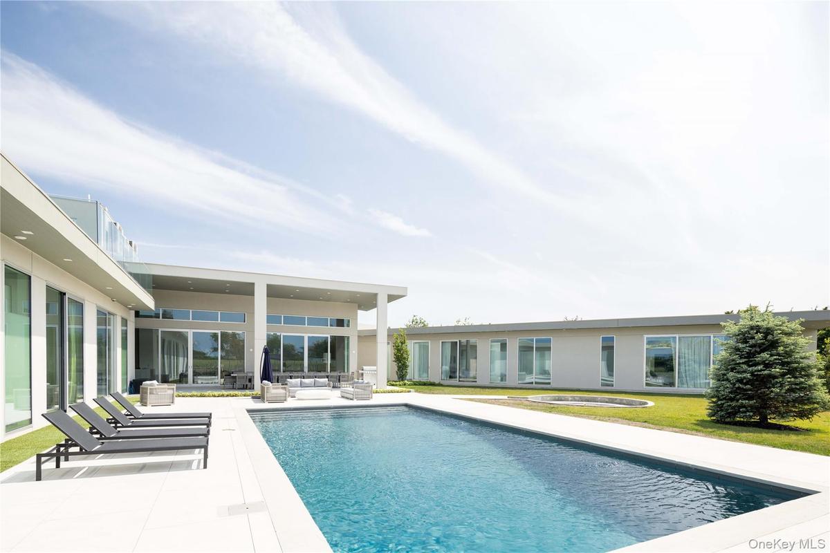 View of pool featuring an outdoor living space, a patio, and a hot tub