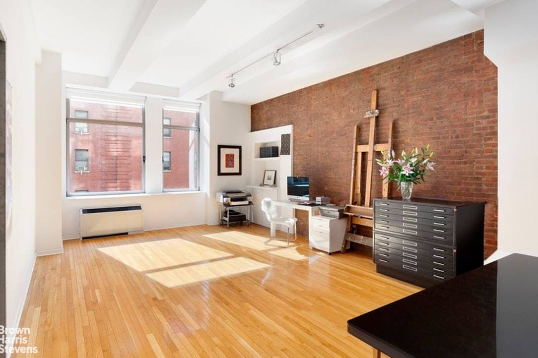Sun flooded all day from extra large south facing windows in both rooms, a true loft with exposed brick walls, long oak plank floors, 11' ceilings, and tons of storage ...