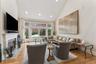 Living room featuring high vaulted ceiling, light wood-style floors, recessed lighting, and a high end fireplace