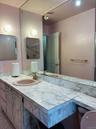 Full bathroom with vanity and an enclosed shower