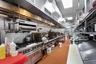 Kitchen featuring high end stainless steel range oven and a paneled ceiling