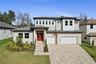 New - custom-built home showcases stunning curb appeal with a modern design, beautiful paver driveway, 3 car oversized garage. Meticulously manicured