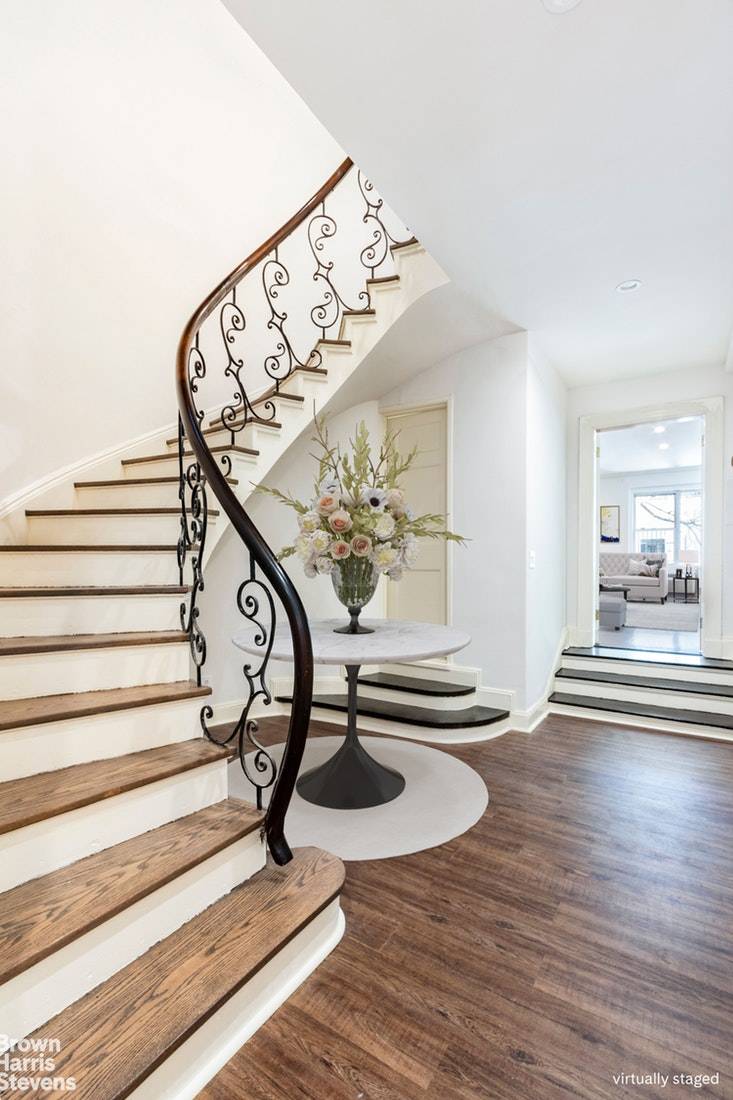Take the elevator up to the top two floors of this massive pre war townhouse apartment with two bedrooms, two and a half bathrooms.