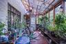Sunroom featuring a tiled floor, exposed wood beam ceiling, and abundant natural light from multiple windows